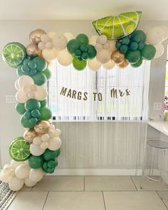 a lemon and lime themed arch with balloons