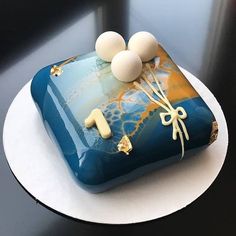 there is a cake with balloons on it