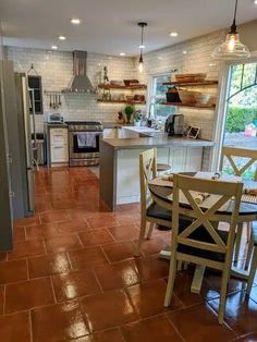 an open kitchen and dining room with tile flooring