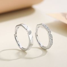 two white gold rings with diamonds on them