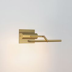 a close up of a light fixture on a wall with the sky in the background