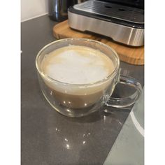 a cup of coffee sitting on top of a counter