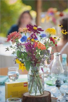 a vase filled with colorful flowers sitting on top of a table