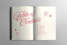 an open book with the title table of contents written in red ink on white paper