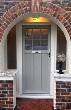 an arched doorway with brick walls and white trim