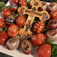 an assortment of painted easter eggs with a cross on top