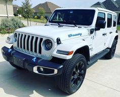 a white jeep parked in front of a house