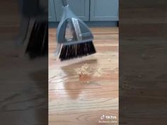 a broom is on the floor with water coming out of it