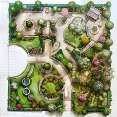 an aerial view of a garden with lots of trees and plants on it, including flowers