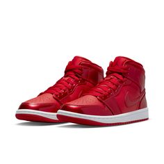 The Nike Womens Air Jordan 1 Mid SE in University Red Pomegranate is a bold and stylish sneaker that is sure to turn heads. This eye-catching shoe features a smooth leather base with glossy synthetic leather overlays, and is accented with perforated toe box and retro Wings logo on the lateral collar flap. The sneaker rides atop a rubber cupsole and is enhanced with an Air-sole heel unit encapsulated in lightweight polyurethane, making it both comfortable and stylish. Womens Air Jordan 1, Womens Air Jordan, Red Nike Shoes, Wmns Air Jordan 1, Red Jordans, Jordan Model, Air Jordan 1 Mid Se, Jordan 11 Retro Low, Womens Air Jordans