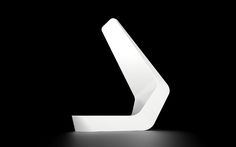 a white sculpture sitting on top of a black surface