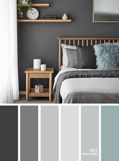 a bedroom with gray walls, white curtains and grey bedding in the center is a wooden