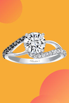 a diamond engagement ring with black and white diamonds on an orange yellow red and pink background