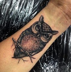 an owl tattoo on the wrist