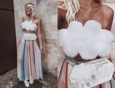 two women standing next to each other in front of a wall with cotton balls on it