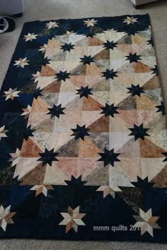 an old quilt is laying on the floor