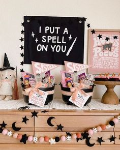 there are some items on the dresser in front of the sign that says, i put a spell on you