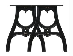 pair of black iron side tables with gold accents on the top and bottom, against a white background