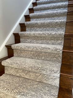 the stairs are made of wood and carpet