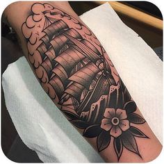 a black and white photo of a ship with flowers on it's arm that is sitting on a towel