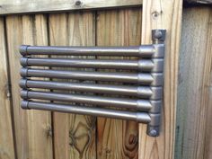 an old metal radiator on a wooden fence