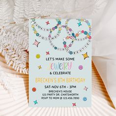 a birthday party card with confetti and stars on it next to white flowers