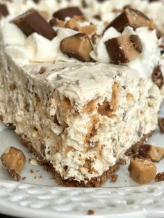 a close up of a piece of cake on a plate with chocolate chips and marshmallows