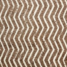 a brown and white rug with wavy lines on it