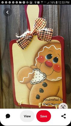 a wooden plaque with a gingerbread dog on it's side hanging from a fence