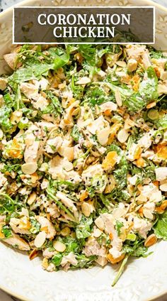 a white bowl filled with chicken salad on top of a table