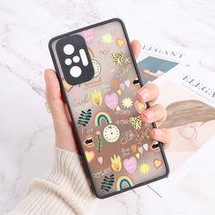 a person holding up a phone case with hearts, flowers and rainbows on it