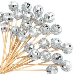 a bunch of crystal beads on sticks with wooden stems in front of a white background