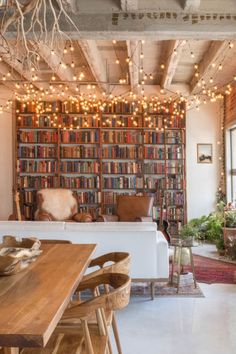 a living room filled with furniture and lots of books