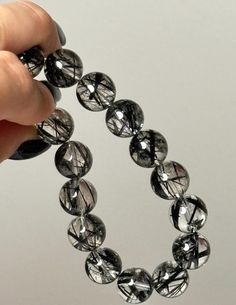 Material:  black Rutilated quartz beads  size :Approx 11mm   quantity: one strand  6mm approx 29 pcs one strands 7mm approx25 pcs one strands 8mm approx 22 pcs one strands 9mm approx 21pcs one strands 10mm approx 19 pcs one strands 11mm approx 18pcs one strands 12mm approx 16 pcs one strands 13mm approx 16 pcs one strands 14mm approx 15 pcs one strands 15mm approx 14pcs one strands 16mm approx 14 pcs one strands 17mm approx 13pcs one strands 18mm approx 13pcs one strands 19mm approx 12pcs one st Healing Stone Bracelet, Quartz Beads, Healing Stone, Rutilated Quartz, Black Tourmaline, Bracelet Jewelry, Gift For Men, Stone Bracelet, Healing Stones