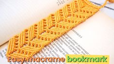 a yellow crocheted bookmark sitting on top of an open book