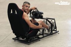 a man sitting in a car seat holding a steering wheel