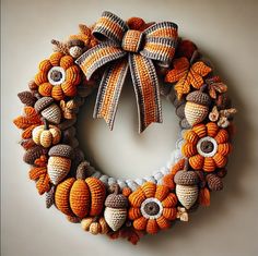 a knitted wreath with autumn leaves and acorns