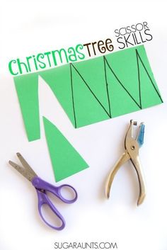 scissors and paper cut out to make a christmas tree ornament for the kids's craft room