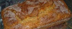 a loaf of bread sitting on top of a metal pan covered in powdered sugar