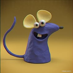 a purple toy with eyes and ears on it's head, standing in front of a yellow background