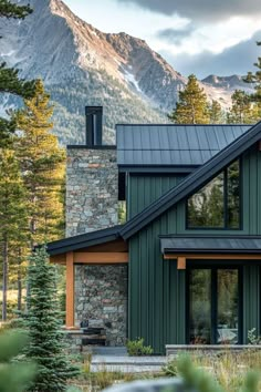 a house in the woods with mountains in the background