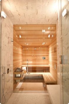 a bathroom with a sauna in the middle and lights on all over it's walls