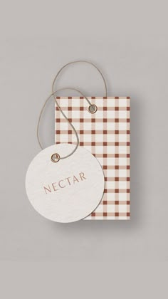 a tag with the word nectar hanging from it's side on a gray background