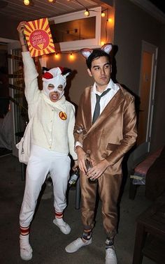 two men dressed in costumes standing next to each other