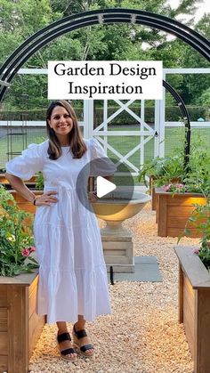 a woman standing in front of some plants