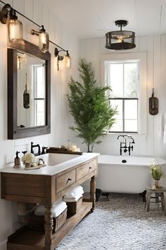 a bathroom with a sink, mirror and bathtub next to a tree in the corner