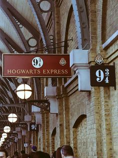 several people are walking down the hall of hogwart's express