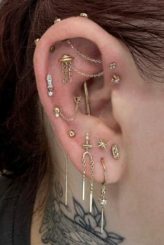 a woman with many piercings on her ear