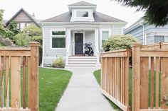 a white house with a black dog on the front door