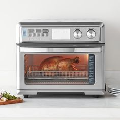 a cat is sitting in an oven with food on the counter next to it,